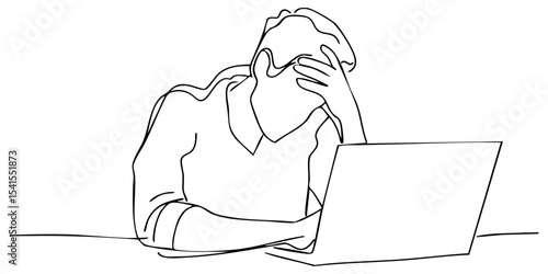 Person experiencing stress while working on a laptop at home during evening hours