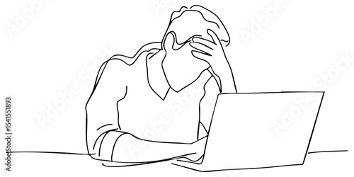 Frustrated person working at a laptop during late hours in a home office setting