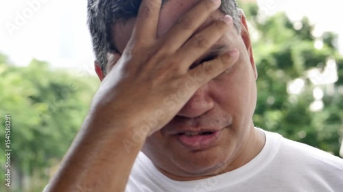 Middle aged old asian man suffering from headache, health and sickness concept for vertigo symptoms, dizziness, stress, stroke, depression, burnout, Alzheimer, brain cancer, PTSD, Meniere disease