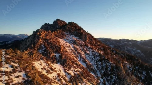 Mountain peak at dawn, snow-capped rocks