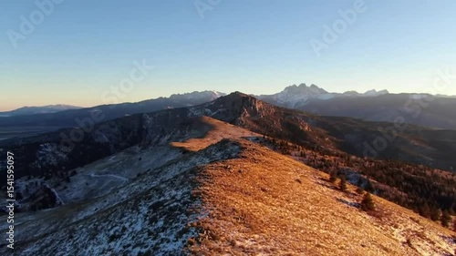 Mountain vista at sunrise with patches of snow