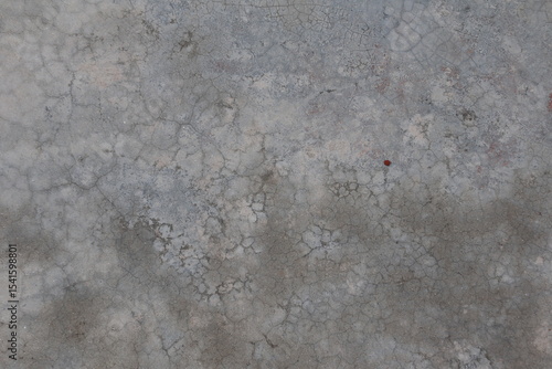 Close-up of a weathered concrete surface with rough texture and gray tones