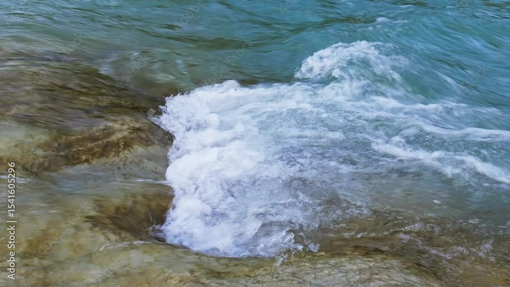 Clear river water flows on a rocky surface Clear river water flows on a rocky surface