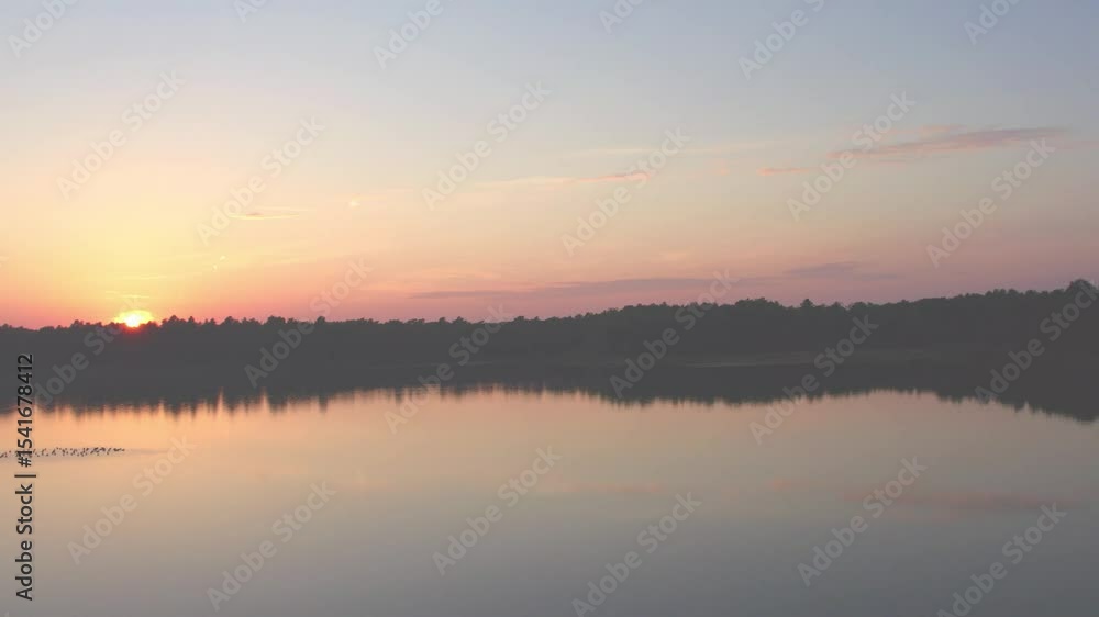 Countryside dramatic and colorful sunset flight over a forest lake, aerial shot on a drone. High quality 4k footage Countryside dramatic and colorful sunset flight over a forest lake, aerial shot on a drone. High quality 4k footage