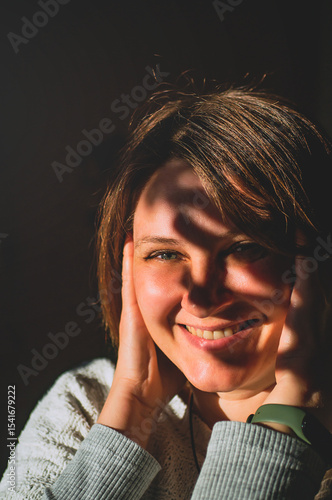 Beautiful girl smiling in the sun rays