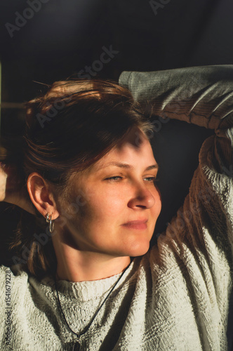 Beautiful girl smiling in the sun rays