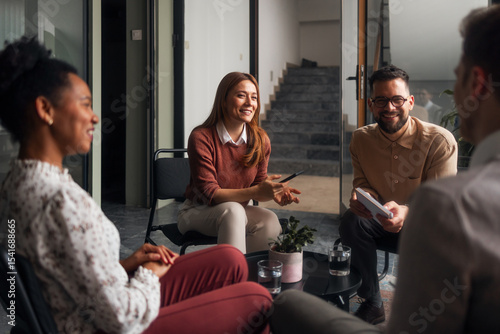 Group of Four People Having a Discussion in a Modern Office