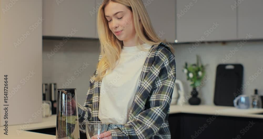 Woman pouring fresh water into glass from jug at home. Health and diet concept. Woman pouring fresh water into glass from jug at home. Health and diet concept.
