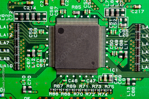 Close-up of a printed circuit board with electronic components, the image symbolizes progress and technological development, creation and production of equipment.
