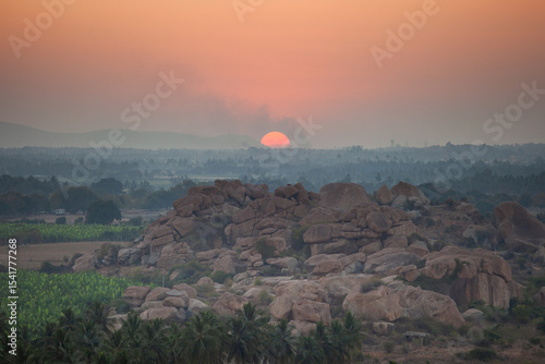Bilde på lerret A serene sunrise or sunset over the ancient landscape of Hampi, India, with a la