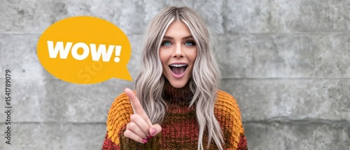 Woman expressing amazement against a textured wall