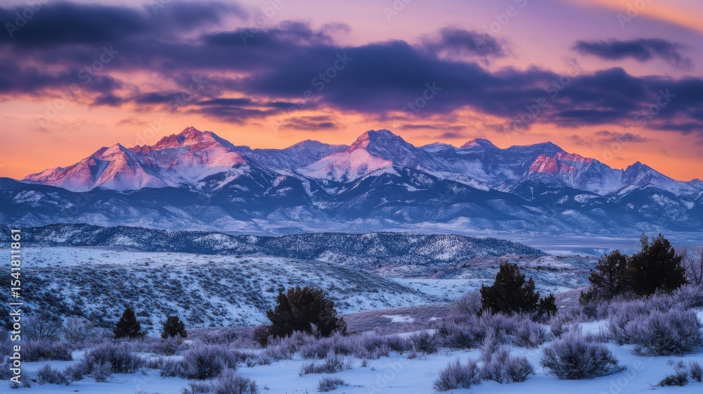 Obraz premium Borealis seen above the Utah mountains in winter covered by snow, with few pines disseminated across the peaks. High-contrast lighting, chiaroscuro, and high definition. cinematic scene