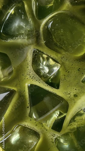Close-Up of Refreshing Iced Matcha Green Tea with Ice Cubes and Frothy Texture in Bright Natural Light