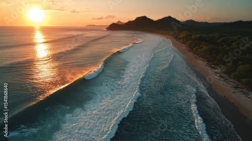 AERIAL: Following a sunset surf session, surfers observe large waves breaking from the shore. magnificent picture of the Pacific Ocean's orange-glow sandy beach. Surf friends visiting the exotic Playa