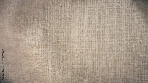 Macro video of textured linen fabric gently fluttering as wind passes