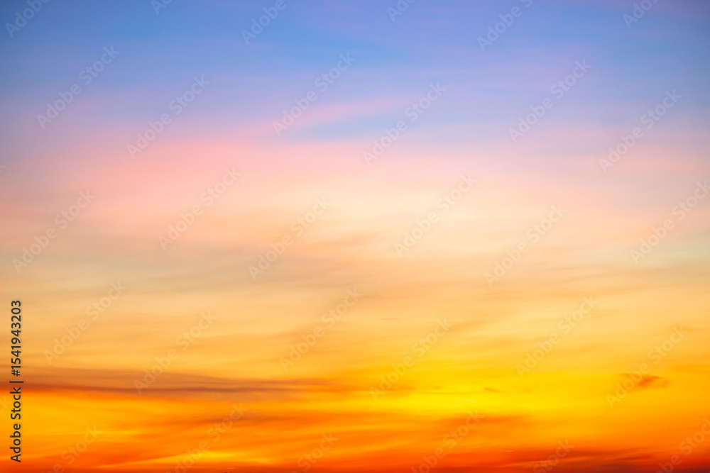 Obraz premium Beautiful , luxury soft gradient orange gold clouds and sunlight on the blue sky perfect for the background, take in evening,Twilight, Large size, high definition landscape photo