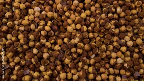 A panning shot captures roasted chickpeas, also known as chana grams, highlighting their texture.