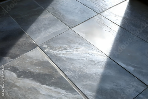 A close-up image of sleek, modern floor tiles reflecting light in an elegant interior space, showcasing texture and design.
