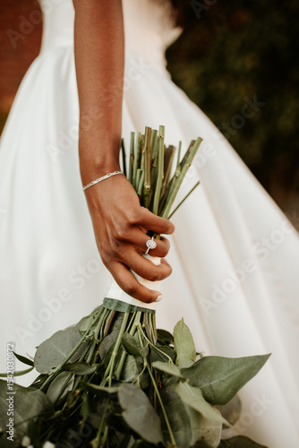 Closeup of black bride holding bouquet
