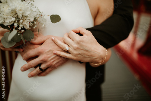 Bride and groom's hands embracing 