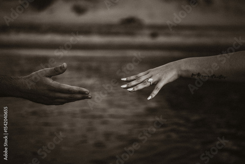 Black and white hands reaching for each other