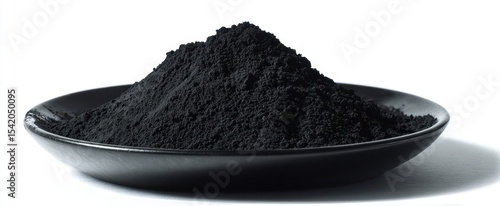 The black powder on a sleek plate isolated against a clean background