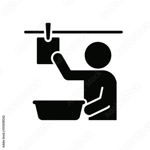 very simple flat and single minimalist Man Developing Photos in the Darkroom Silhouettes in black on a white background