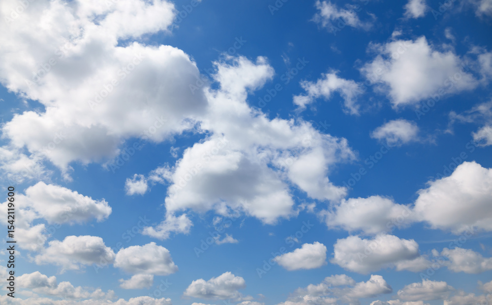 Fototapeta premium A beautiful blue sky with soft, white clouds, for an abstract background