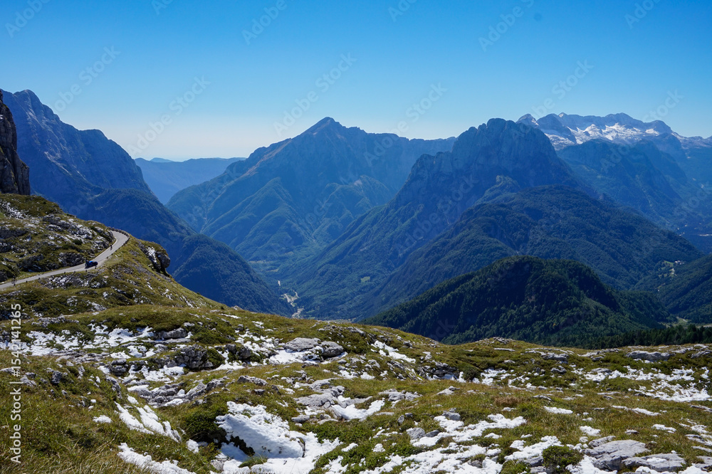 Breathtaking Panoramic View of Majestic Mountains and Winding Road in Triglav National Park, Julian Alps, Slovenia on a Clear Sunny Day Breathtaking Panoramic View of Majestic Mountains and Winding Road in Triglav National Park, Julian Alps, Slovenia on a Clear Sunny Day