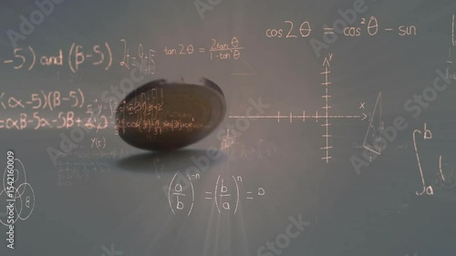 Upward flicking coin flipping and spinning against chalkboard, wobbling landing showing momentum