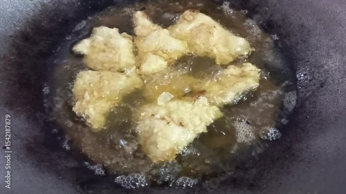 View of fried karage chicken from raw to frying in a frying pan using medium heat so that it can be cooked through to the inside