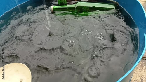 view of rainwater falling and droplets falling into the bucket and creating a nice and cool view
