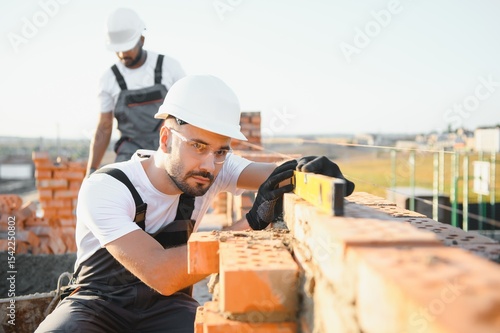 Tableau sur toile Group of workers at a construction site