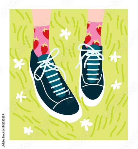 Feet on the grass, wearing sneakers with bright socks.