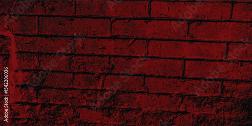 Vertical and horizontal lines of a textured red wall, creating a strong sense of structure and orderly repetition with deep shadows.
