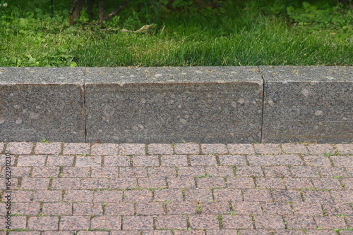 granite curb on green lawn, cobblestone pavement, gray curbstone, 2