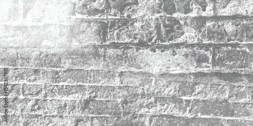 Monochrome photograph of a stone wall, emphasizing its form, shadows, and the interplay of light on its rugged surface.
