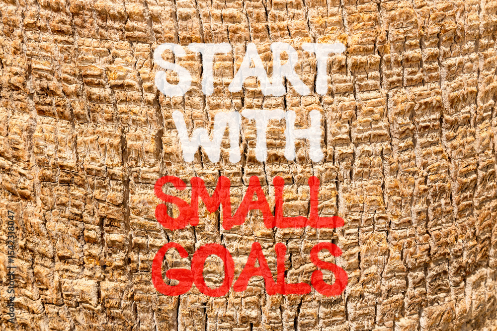 Fototapeta premium Start with small goals symbol. Concept words phrase Start with small goals on beautiful palm tree bark. Beautiful palm tree bark background. Business Start with small goals concept. Copy space.