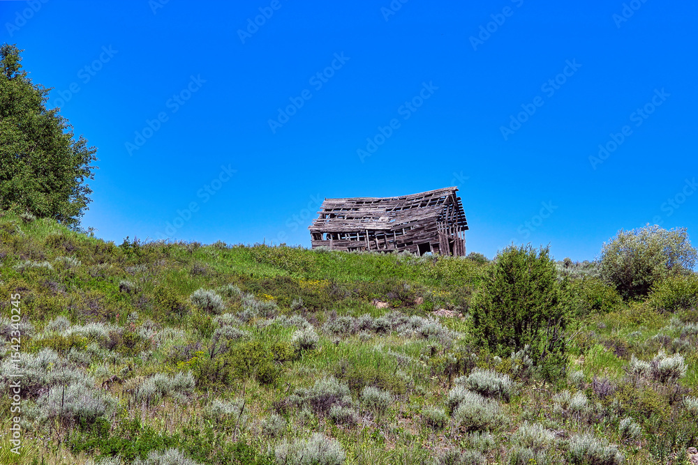 Old Rundown Wooden Barn on a Hill on Highway 32, Teton Scenic Byway in Idaho. Old Rundown Wooden Barn on a Hill on Highway 32, Teton Scenic Byway in Idaho.
