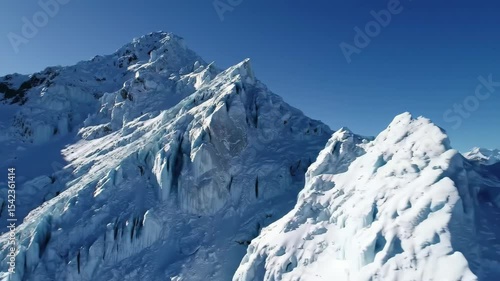 Wallpaper Mural Majestic Snowy Mountain Peaks Under Clear Blue Sky, Ice Formations Visible Torontodigital.ca