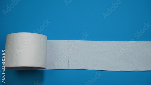 Eight rolls of toilet paper disappear. One roll of toilet paper unrolls on a blue background