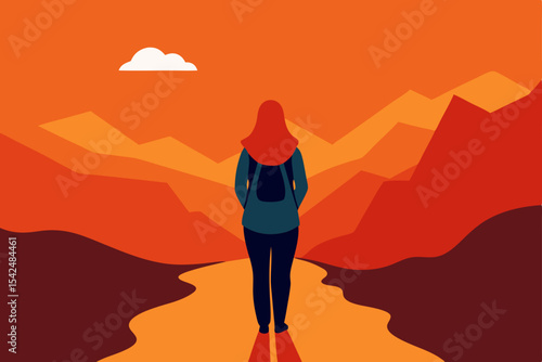 Silhouetted hikers, a man and woman, walk atop a desert mountain dune at sunset