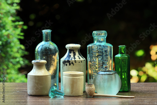 A selection of Victorian household items. There are bottles, stoneware and a clay pipe.