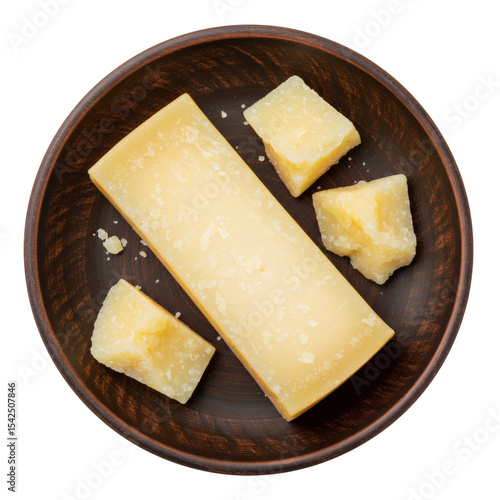 Parmesan cheese block and chunks on dark wooden plate, top view, isolated