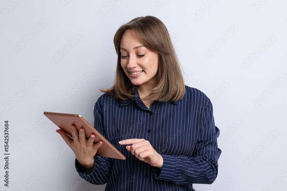 Fototapeta premium Woman with modern tablet on white background