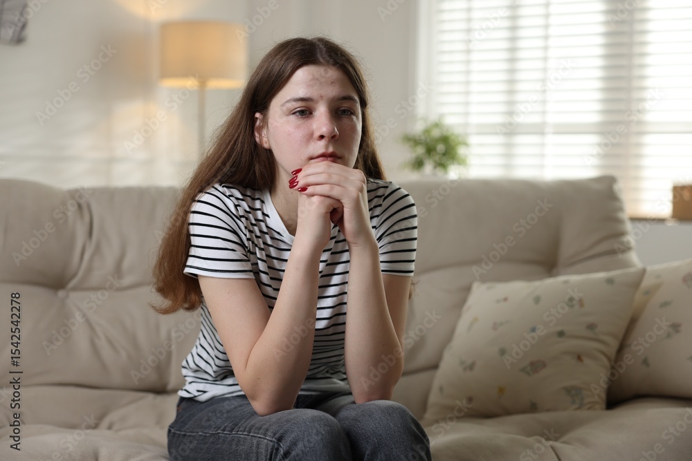 Depressed teenage girl on sofa at home Depressed teenage girl on sofa at home
