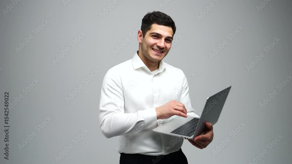 Young Professional Engages With Laptop While Smiling, Showcasing Enthusiasm for Work in a Bright, Modern Setting Young Professional Engages With Laptop While Smiling, Showcasing Enthusiasm for Work in a Bright, Modern Setting