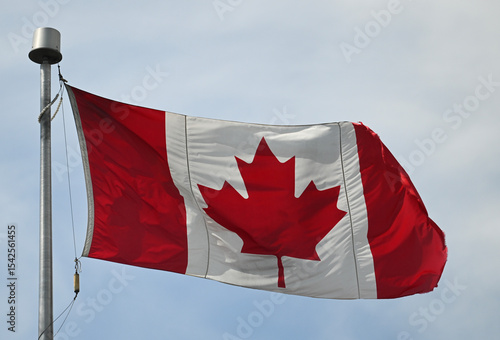 A Canadian flag flaps in the wind