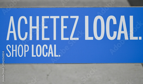 A shop local sign in French and English