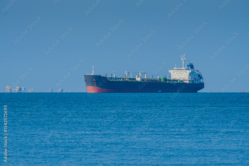 Fototapeta premium Explorer Tanker near Balikpapan Bay with Distant Oil Rigs